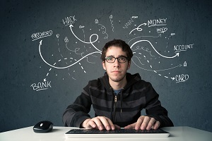 YOung Guy working on computer with words coming out of his head